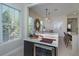 Open-concept breakfast bar with wine fridge, modern lighting, and seating, perfect for entertaining at 528 Lobelia Dr, Lake Mary, FL 32746