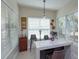 Bright breakfast bar with marble countertop and comfortable seating, lit by modern pendant lighting at 528 Lobelia Dr, Lake Mary, FL 32746