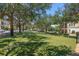 Beautiful green common area featuring manicured grass, trees, and a sprinkler system at 528 Lobelia Dr, Lake Mary, FL 32746