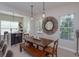 Open dining area with wood table and seating, modern lighting, and adjacent breakfast bar at 528 Lobelia Dr, Lake Mary, FL 32746