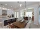 Dining area featuring wood table and seating, modern light fixtures, breakfast bar and open kitchen at 528 Lobelia Dr, Lake Mary, FL 32746