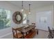 Inviting dining room with stylish mirror, wooden table, and lots of natural light at 528 Lobelia Dr, Lake Mary, FL 32746