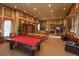 Spacious game room with pool table, comfortable seating, and a kitchenette area at 528 Lobelia Dr, Lake Mary, FL 32746