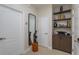 Entryway with a modern mirror, white trim, and a built-in cabinet with shelving at 528 Lobelia Dr, Lake Mary, FL 32746