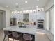 Modern kitchen featuring a large marble island, stainless steel appliances, and white cabinetry at 528 Lobelia Dr, Lake Mary, FL 32746