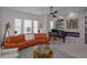 Stylish living room with curved sofa, piano, and accent fireplace with decorative shelving at 528 Lobelia Dr, Lake Mary, FL 32746