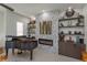 Living room featuring piano, accent fireplace, and shelving with decorative items at 528 Lobelia Dr, Lake Mary, FL 32746