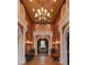 Grand lobby featuring elegant columns, a chandelier, and lush indoor plants at 528 Lobelia Dr, Lake Mary, FL 32746