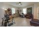 Spacious home office with lots of light, wood floors, built-in shelving, and leather furniture at 528 Lobelia Dr, Lake Mary, FL 32746