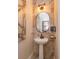 Elegant powder room with marble walls, pedestal sink, and decorative lighting at 528 Lobelia Dr, Lake Mary, FL 32746