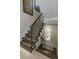 Modern staircase with glass railings and natural wood steps at 528 Lobelia Dr, Lake Mary, FL 32746
