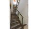 Modern staircase with wood steps, glass railing, and natural light from a window at 528 Lobelia Dr, Lake Mary, FL 32746