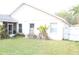 The backyard has a screened-in lanai. The yard is fenced and has a small plant growing near the house at 536 Dunoon St, Ocoee, FL 34761
