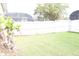 The backyard has a fence, green grass, and growing plants at 536 Dunoon St, Ocoee, FL 34761