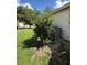 Backyard featuring a modern A/C unit nestled in a bed of gravel and bordered by lush landscaping at 536 Dunoon St, Ocoee, FL 34761