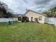 Spacious backyard featuring a lush lawn, a screened lanai, and a playset for outdoor fun at 536 Dunoon St, Ocoee, FL 34761