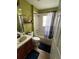 Cozy bathroom with a shower-tub combo and dark brown vanity at 536 Dunoon St, Ocoee, FL 34761