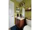 Bright bathroom featuring a vanity with white countertop and a decorative shelf at 536 Dunoon St, Ocoee, FL 34761