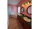 Bathroom with a corner tub, double sinks, and light fixtures above the mirrors at 536 Dunoon St, Ocoee, FL 34761