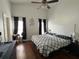 Spacious bedroom with dark curtains, a ceiling fan, and a decorative headboard at 536 Dunoon St, Ocoee, FL 34761