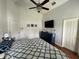 Bright bedroom featuring a ceiling fan and dresser beneath a wall-mounted television at 536 Dunoon St, Ocoee, FL 34761