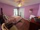 Bedroom with hardwood floors, ceiling fan, and a double bed at 536 Dunoon St, Ocoee, FL 34761