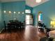 Open dining room features modern lighting, wood floors, and an open doorway with plenty of natural light at 536 Dunoon St, Ocoee, FL 34761