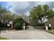 Gated entrance to a neighborhood featuring wrought iron and brick accents at 536 Dunoon St, Ocoee, FL 34761