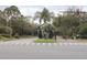 Gated community entrance featuring palm trees, professional landscaping, and a guard house at 536 Dunoon St, Ocoee, FL 34761