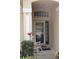 Welcoming front porch with a rocking chair, decorative plants, and a stylish screen door at 536 Dunoon St, Ocoee, FL 34761