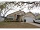Charming single-story home with a well-maintained lawn, inviting front entrance, and an attached two-car garage at 536 Dunoon St, Ocoee, FL 34761