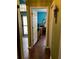 Hallway with hardwood flooring, doorframe, and green walls at 536 Dunoon St, Ocoee, FL 34761