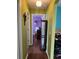 Hallway with wood flooring that leads to a bedroom with purple walls at 536 Dunoon St, Ocoee, FL 34761