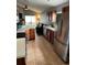 Bright kitchen features stainless steel appliances, wood cabinetry, and tiled floor at 536 Dunoon St, Ocoee, FL 34761