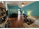 Open-concept living room and dining area features hardwood floors and blue accent wall at 536 Dunoon St, Ocoee, FL 34761
