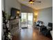 Inviting living room with a fireplace, vaulted ceiling, and sliding glass doors to a patio at 536 Dunoon St, Ocoee, FL 34761