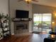Cozy living room with a fireplace and sliding glass doors leading to an outdoor patio area at 536 Dunoon St, Ocoee, FL 34761