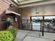 Community pool area featuring office hours sign, fenced entry, and covered seating at 536 Dunoon St, Ocoee, FL 34761