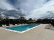 Community swimming pool featuring lounge chairs, a shaded pergola, and clear blue water at 536 Dunoon St, Ocoee, FL 34761