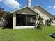 Screened-in porch with a fan and furnishings, offering a comfortable outdoor living space with a grill at 536 Dunoon St, Ocoee, FL 34761