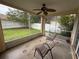 View from screened-in porch with a ceiling fan and chairs, overlooking the meticulously maintained and fenced backyard at 536 Dunoon St, Ocoee, FL 34761