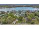 Community aerial view with lakefront access and neighborhood homes surrounded by mature trees at 5569 Jessamine Ln, Orlando, FL 32839