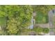 Overhead view of the property showcasing the landscaping, driveway, and surrounding lush greenery at 5569 Jessamine Ln, Orlando, FL 32839