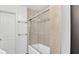 Bright bathroom with a shower-tub combination enclosed with sliding glass at 5569 Jessamine Ln, Orlando, FL 32839