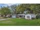Charming single-story home with well-manicured front yard, inviting curb appeal, and attached garage at 5569 Jessamine Ln, Orlando, FL 32839