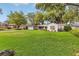 Beautiful single-story home with manicured lawn, driveway, and trees at 5569 Jessamine Ln, Orlando, FL 32839