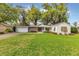 Charming single-story home with a lush green lawn and a brick-paved driveway at 5569 Jessamine Ln, Orlando, FL 32839