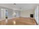 Inviting living room with hardwood floors and cozy fireplace at 5569 Jessamine Ln, Orlando, FL 32839