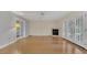Bright living room featuring hardwood floors and double French doors at 5569 Jessamine Ln, Orlando, FL 32839