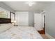 Well-lit bedroom features a closet, a large bed, a side table with lamp, and a window for ample natural light at 7 Clarendon Ct, Daytona Beach, FL 32118